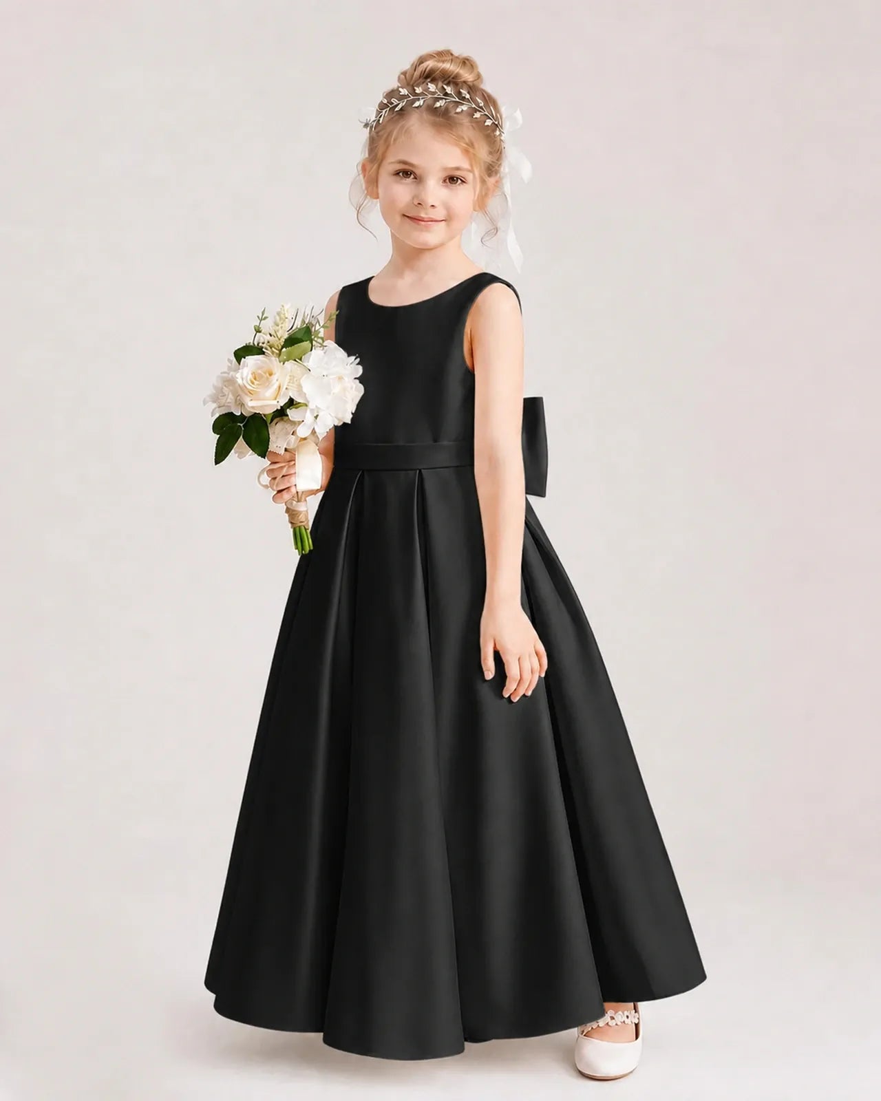 Black satin A-line flower girl dress, side view.