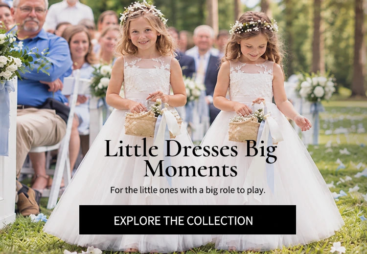 Two flower girls in white tulle dresses carrying flower baskets down the aisle at an outdoor wedding